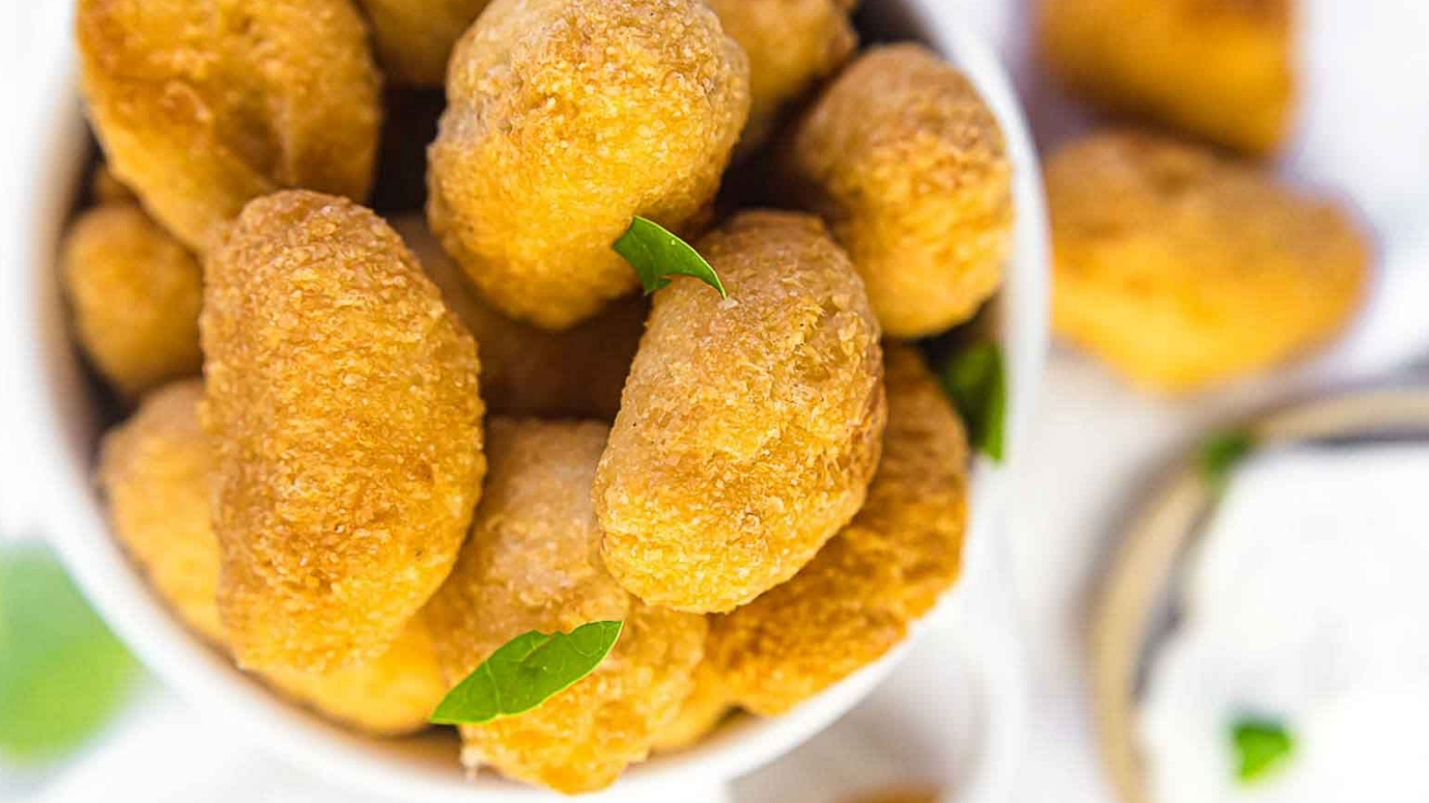 Extra Crispy Keto Tater Tots Croquettes inside white bowl.