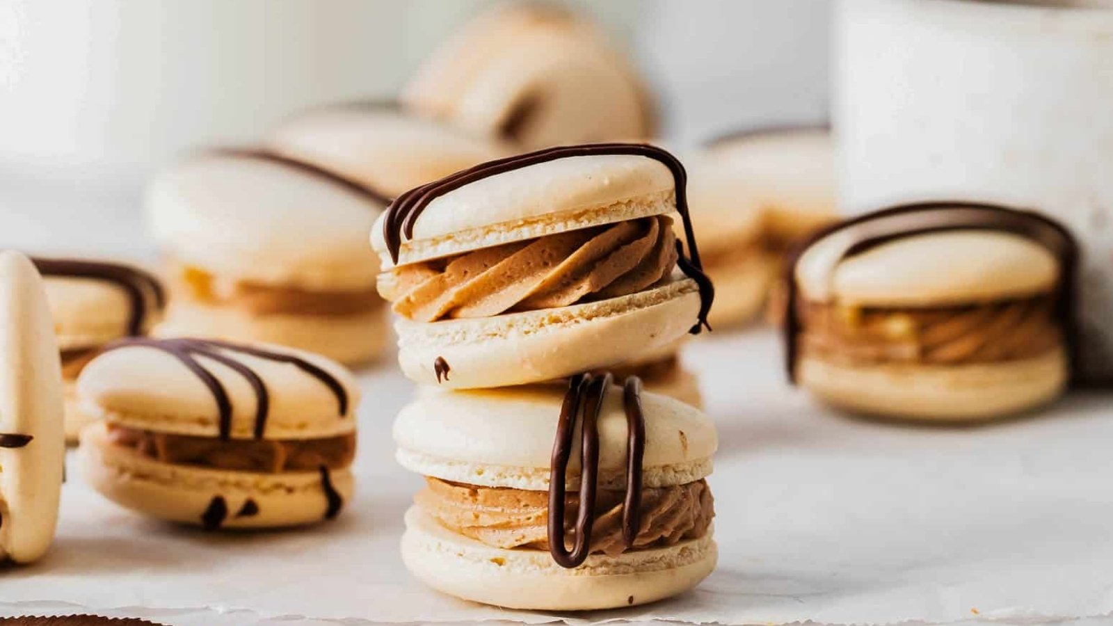 German chocolate macarons with chocolate ganache drizzle.