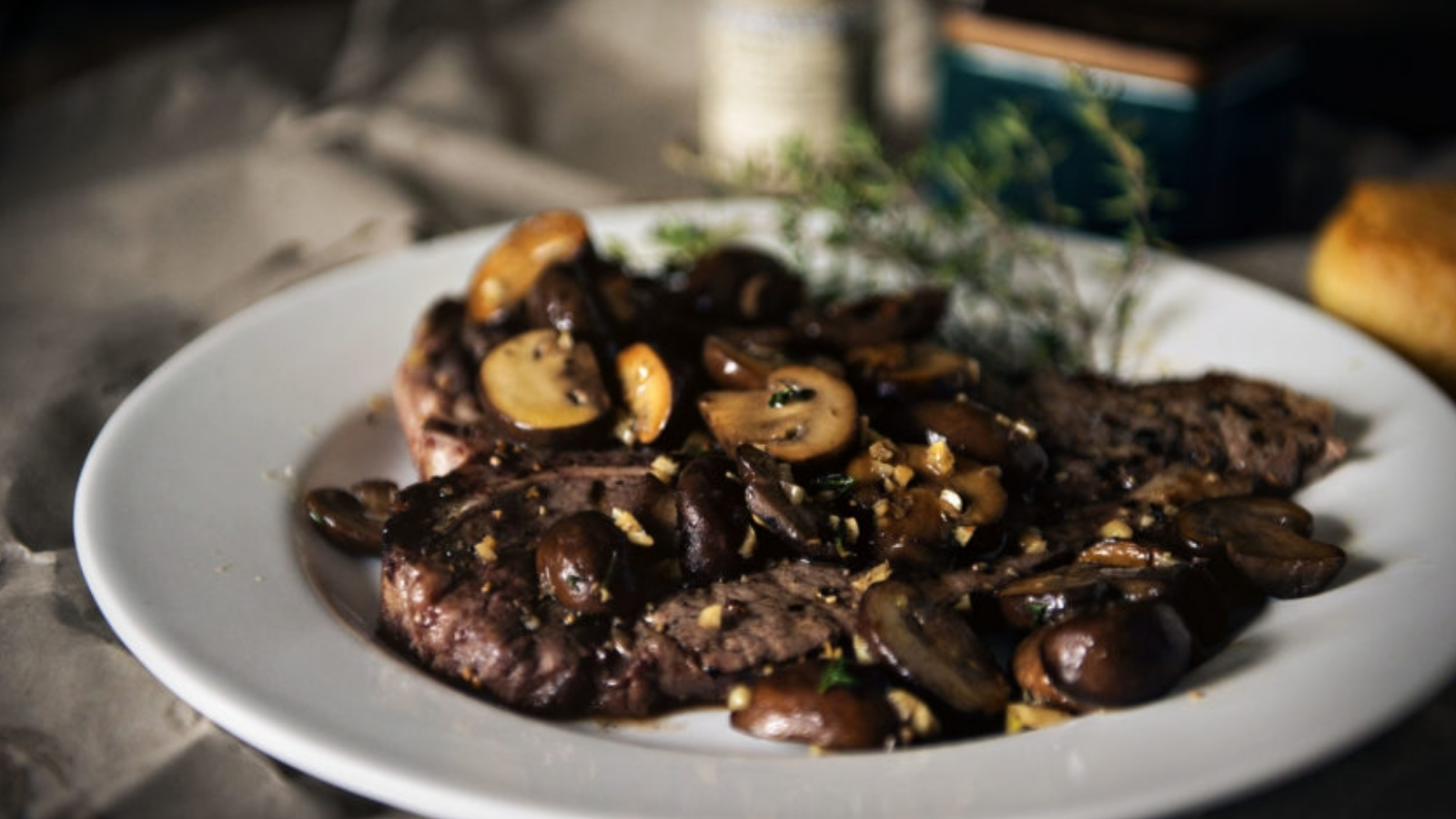 T-bone steaks grilled with thyme mushrooms sautéed alongside.