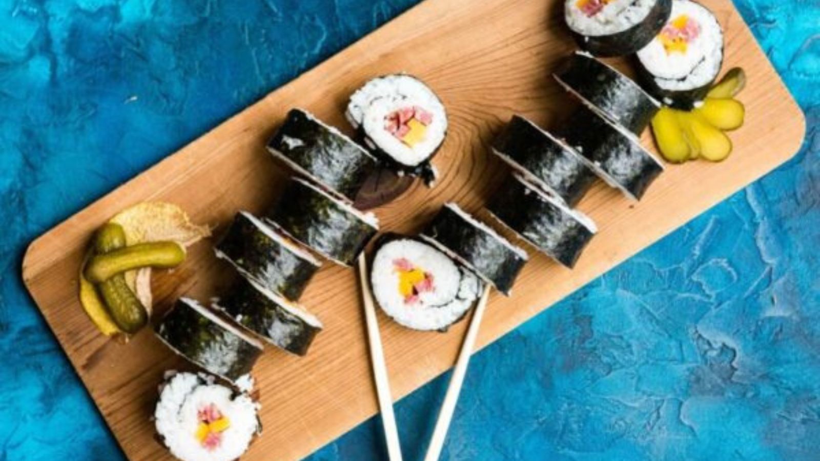 Beefshi roll sliced to show rice-wrapped beef with fillings arranged neatly inside each piece.