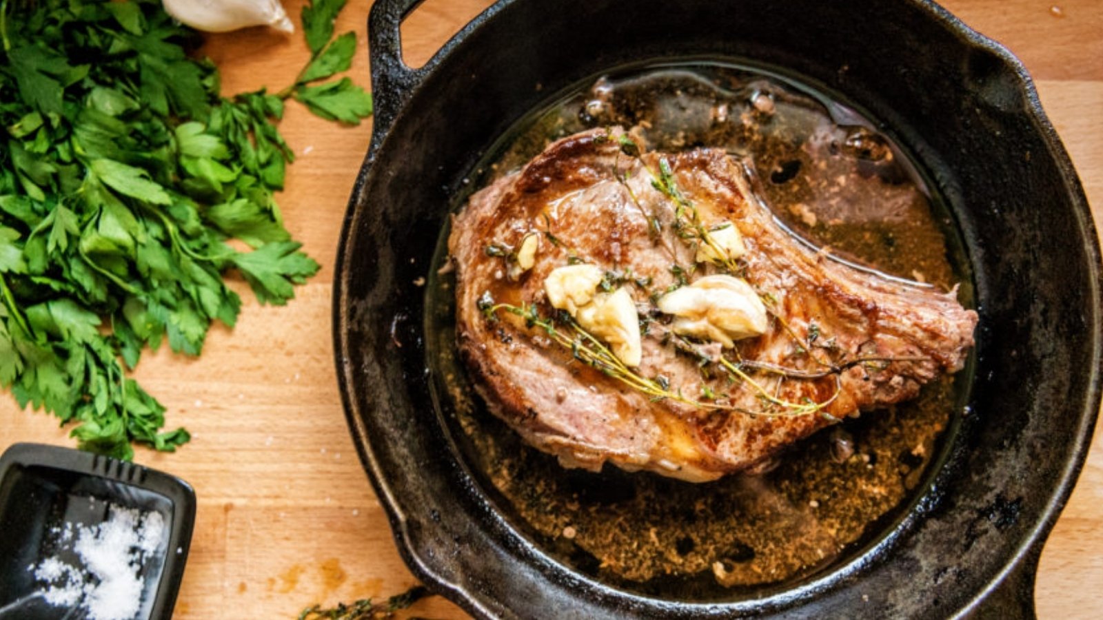 Ribeye pan-seared with garlic butter creating crisp crust and juicy center.