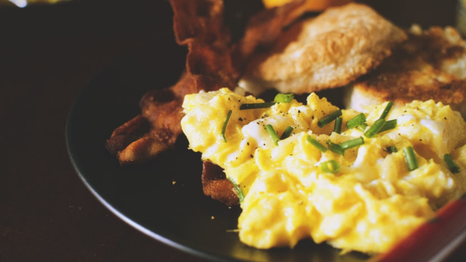 Scrambled eggs fluffy with biscuits fried in bacon fat.