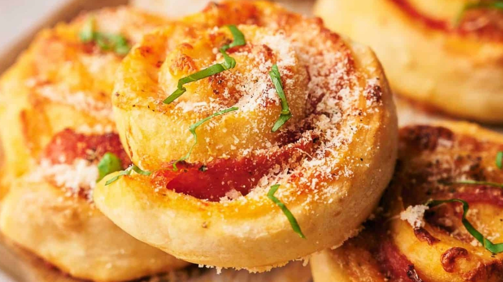 Freshly made pizza rolls stacked on each other.