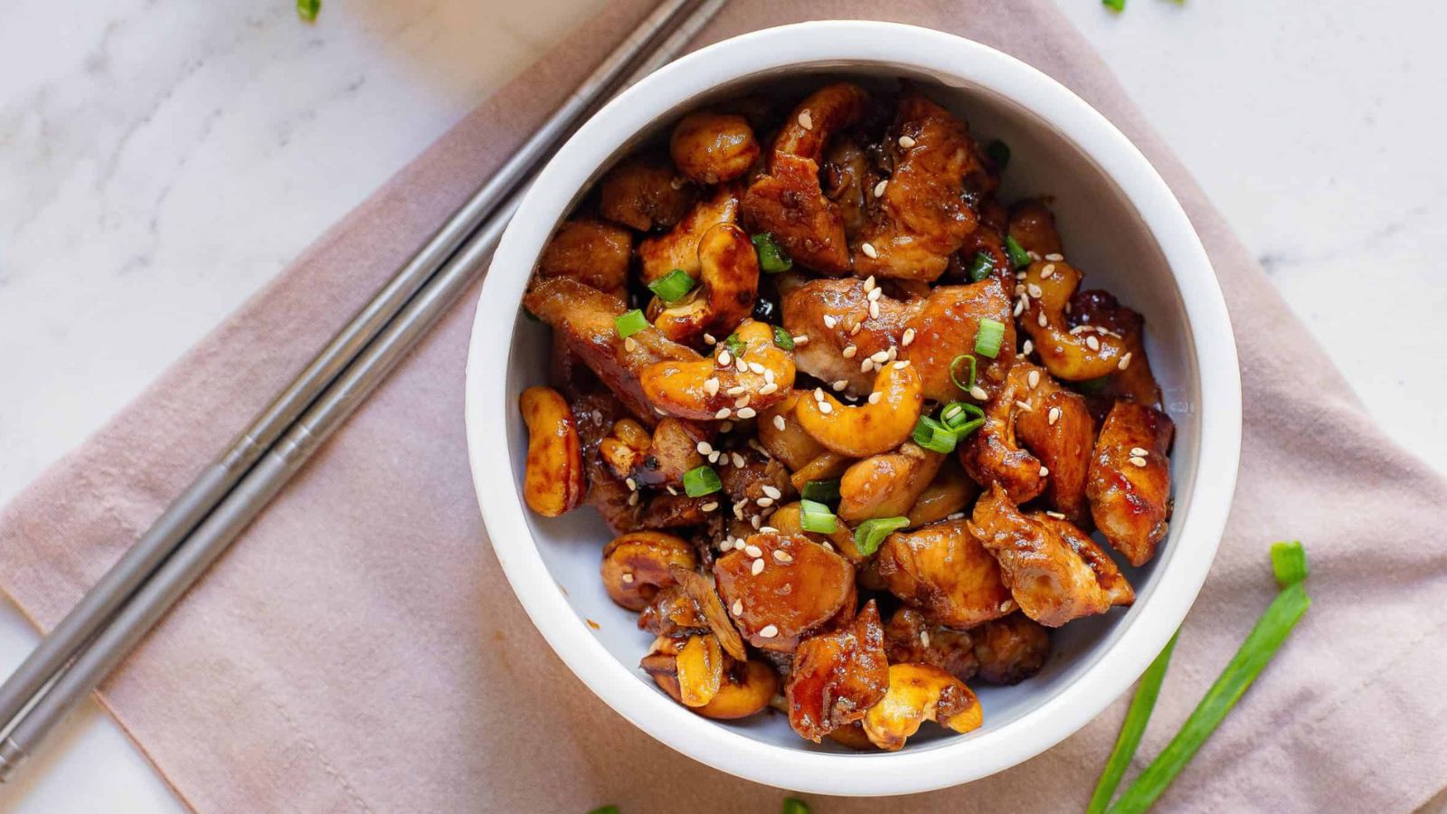 Sheet Pan Honey Soy Cashew Chicken with sesame seeds and chopsticks.