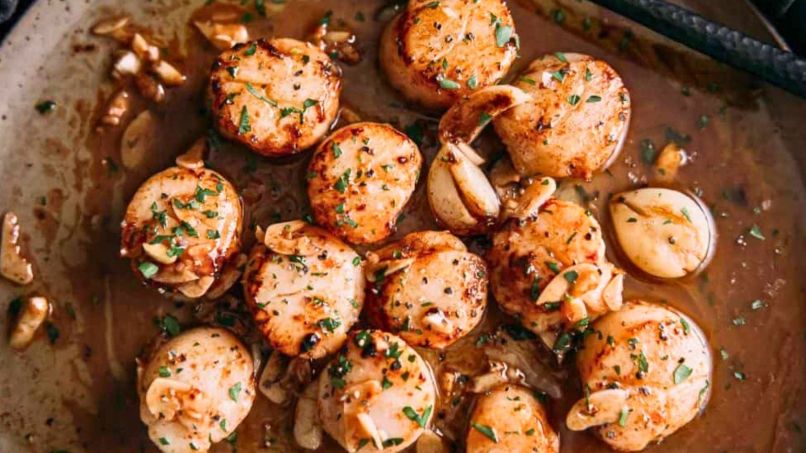 Sous vide scallops with brown butter sauce poured over seared golden tops.