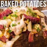A baked potato topped with corned beef, onions, melted cheese, and creamy sauce, garnished with chopped parsley. Text overlay reads, “Corned Beef Stuffed Baked Potatoes.”.