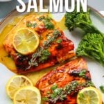 Two pieces of honey glazed salmon garnished with lemon slices and herbs, served with broccoli on a plate. Text overlay reads: "How to make honey glazed salmon.