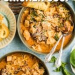 Overhead view of bowls filled with creamy chicken soup topped with herbs and grated cheese, alongside bread slices and a block of cheese. Text overlay promotes a chicken soup recipe.