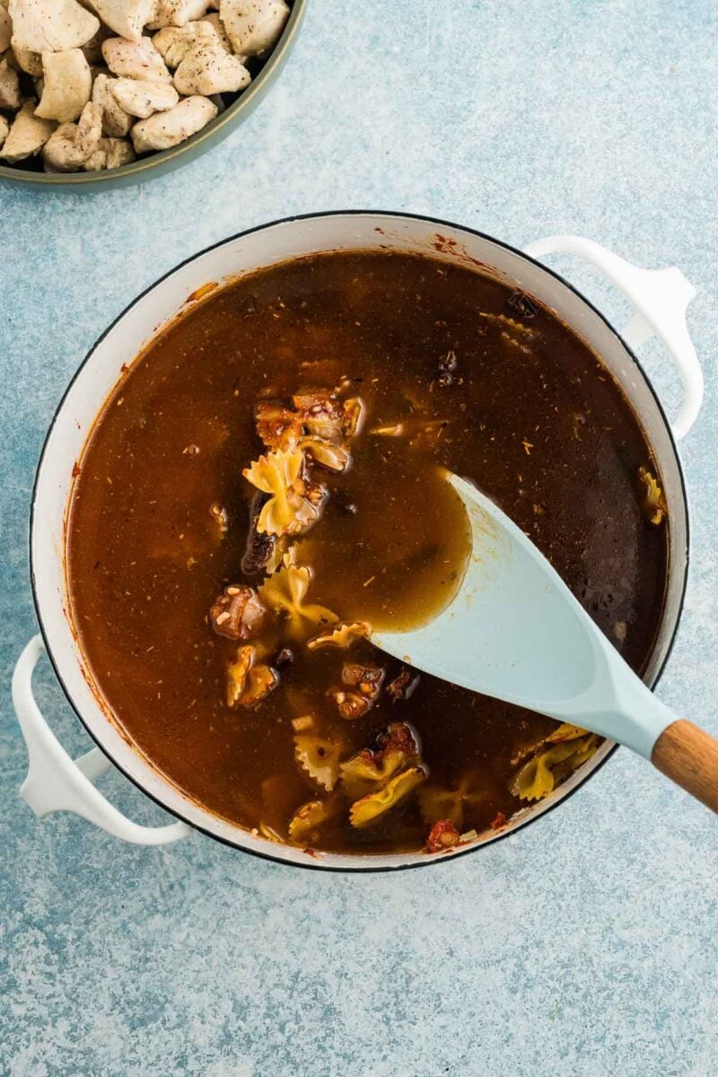 A pot of soup with a ladle.