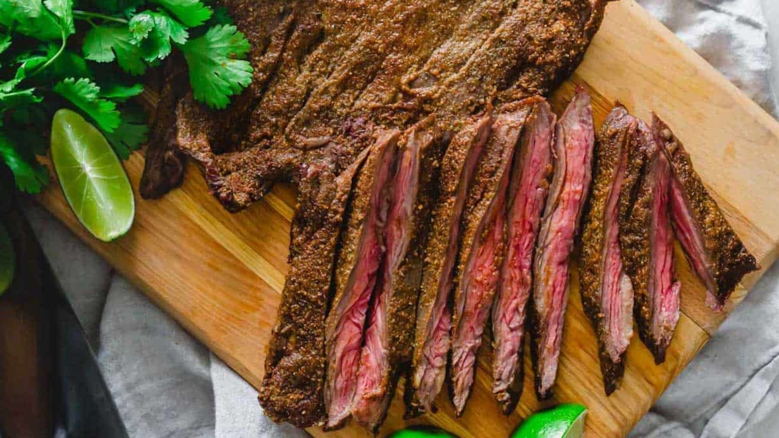 Air fryer skirt steak sliced on a cutting board.