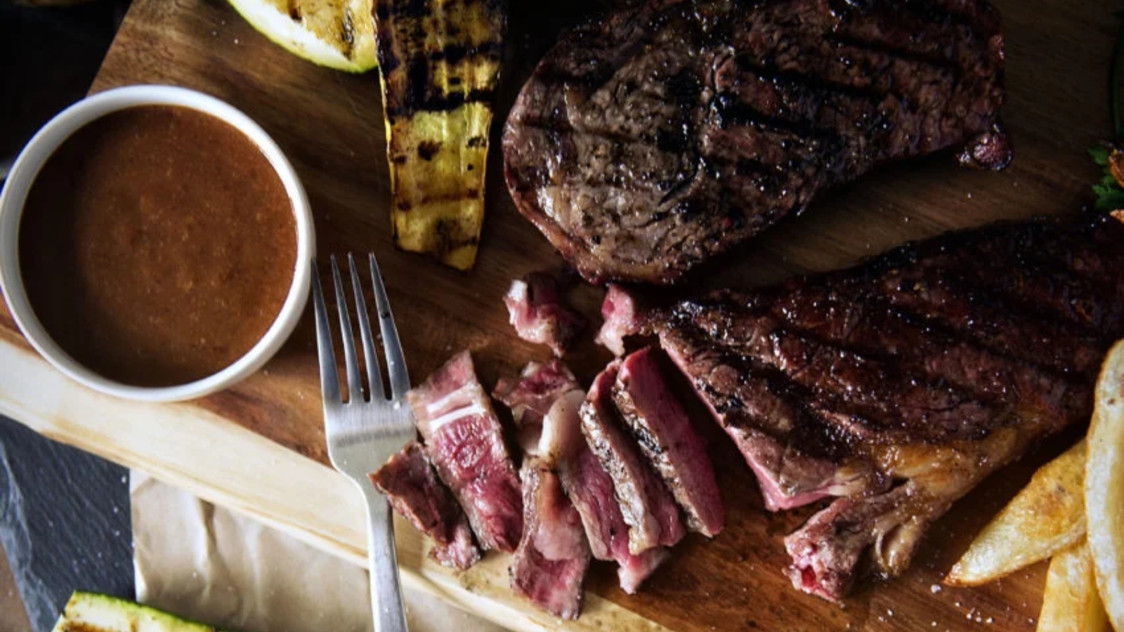 Charcoal grilled steak seared dark with smoky crust.