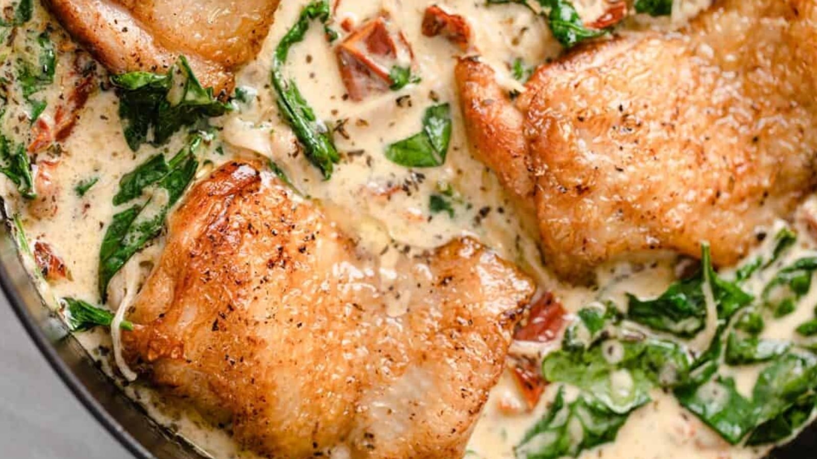 Creamy Tuscan chicken in a skillet.