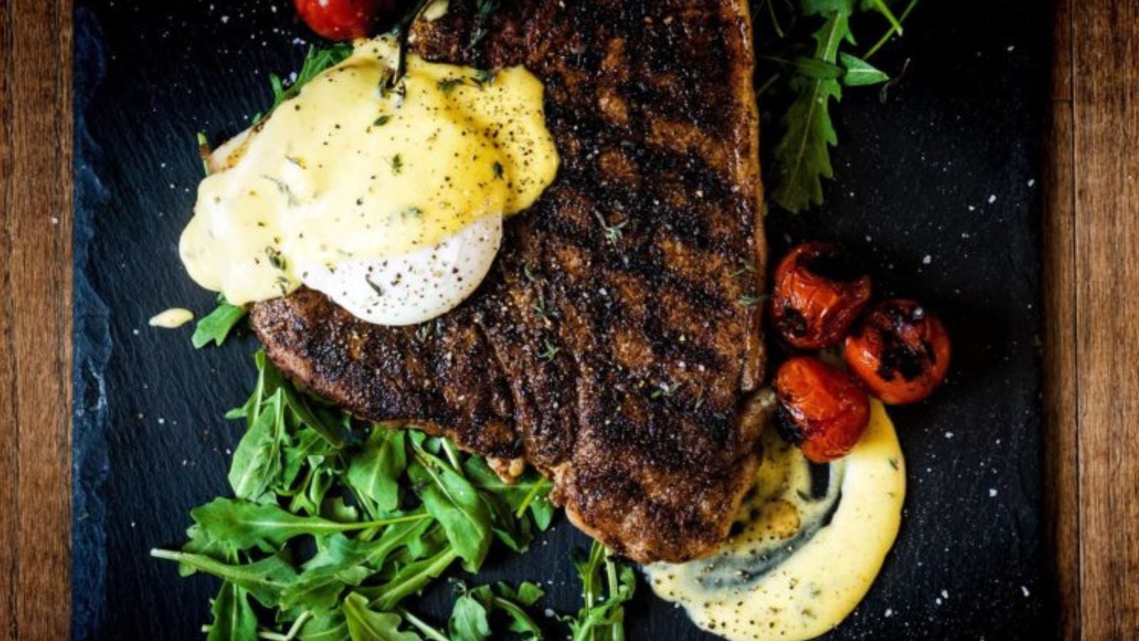 T-bone steak grilled with espresso rub topped with poached egg and hollandaise.