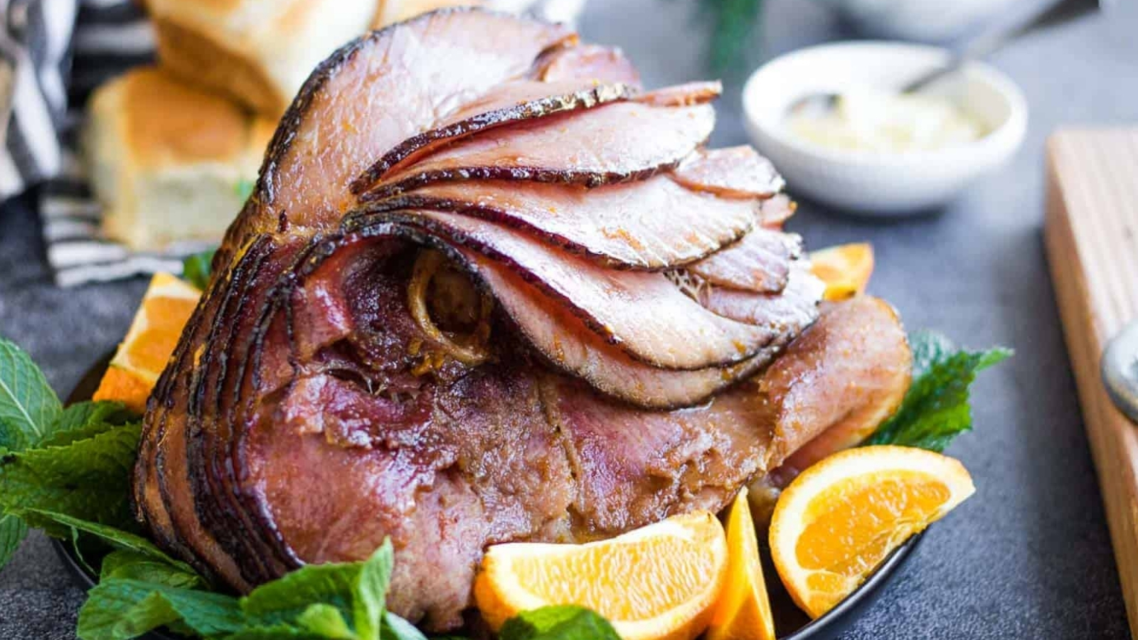 Sliced ham with oranges and mint.
