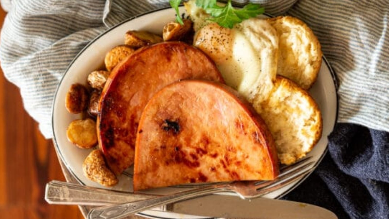 Ham steaks seared and glazed with maple served with red-eye gravy drizzled over.
