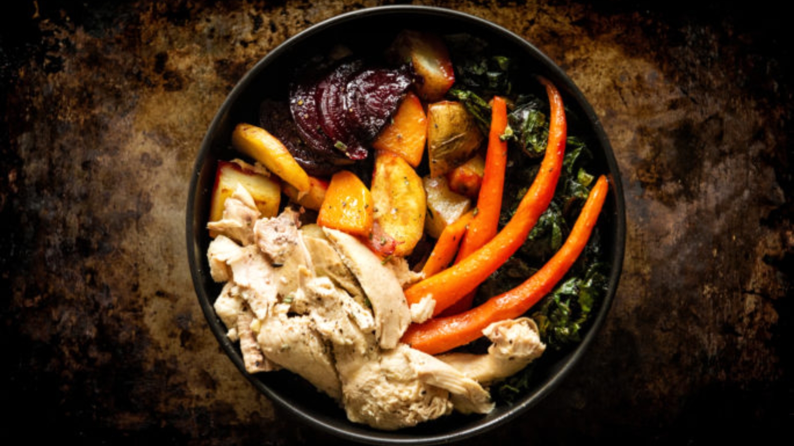 Roasted root vegetables with grilled chicken served in hearty bowl with maple aioli.