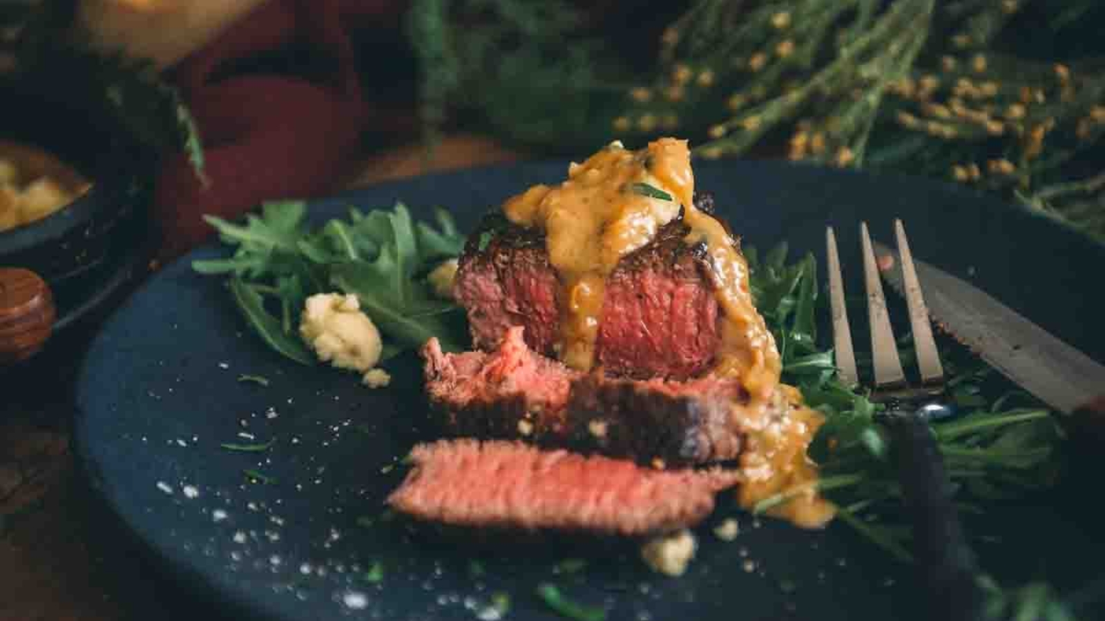 Sous vide filet mignon seared dark and sliced thick to reveal perfect doneness.