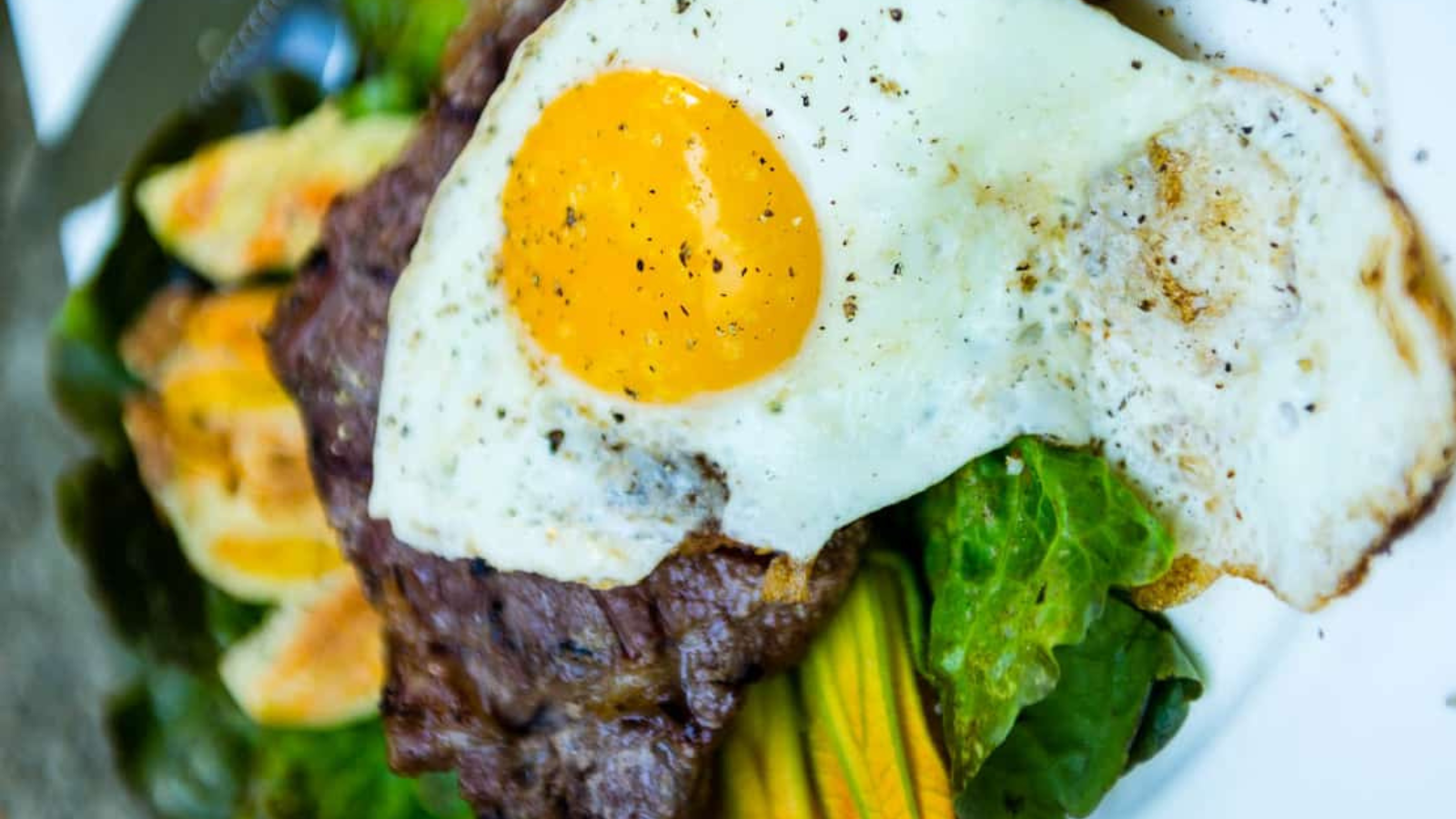 Steak and eggs cooked sous vide with browned seared edges.