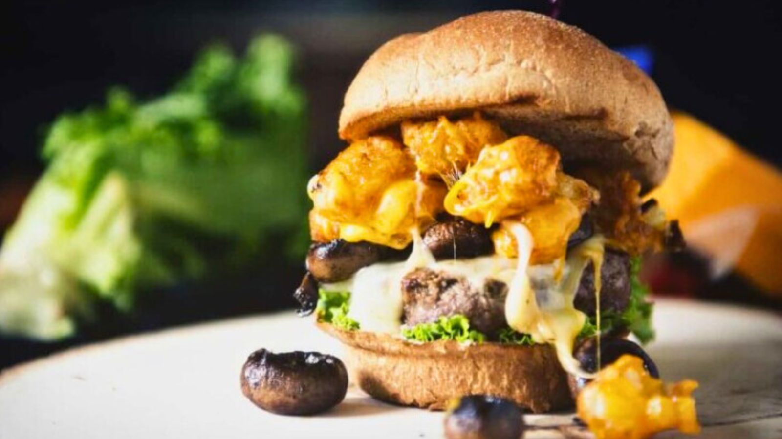 Burger topped with mashed potatoes layered high.