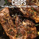 Pan-seared lamb shoulder chops cooked in a skillet with garlic herb butter, garnished with fresh herbs. Text overlay gives recipe details and website link.