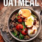 A bowl of savory oatmeal topped with soft-boiled eggs, sautéed tomatoes, greens, and a spicy sauce, placed on a rustic mat with a spoon beside it. Text reads "How to Make Savory Oatmeal.