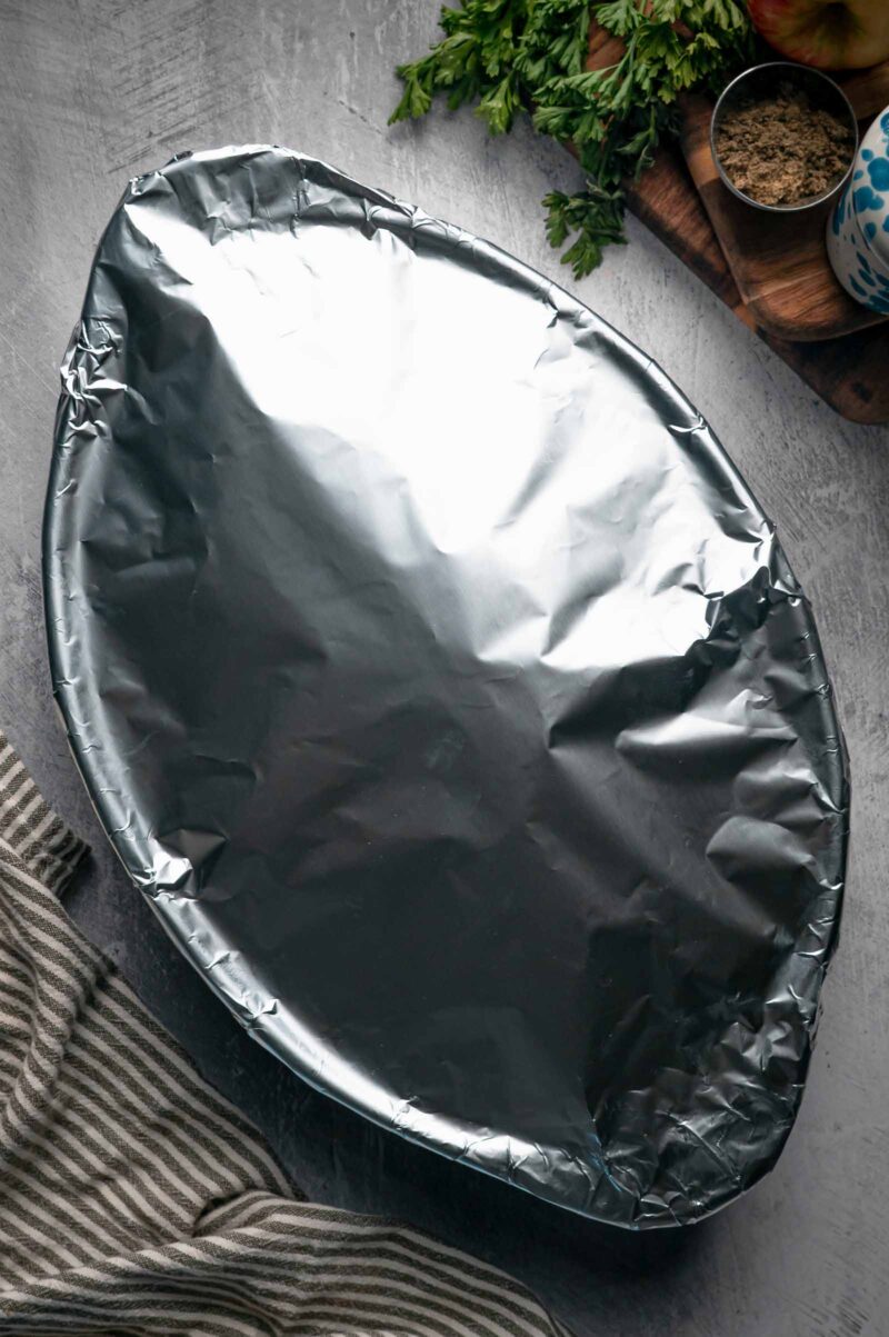 The baking dish of stuffing covered tightly with aluminum foil for the first 25 minutes in the oven.