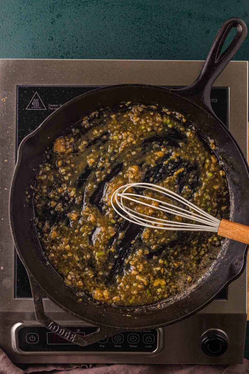 The miso butter sauce whisked smooth in the skillet, garlic and minced scallion whites melted into the browned fond.