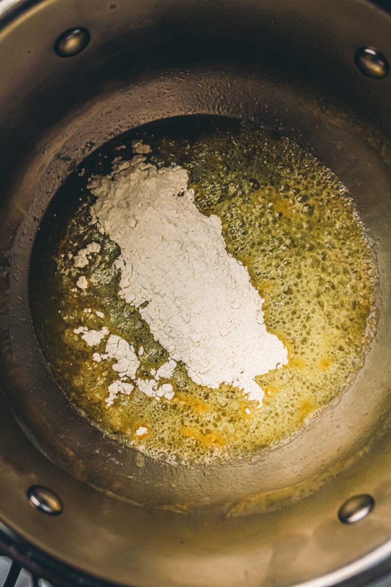 Flour added to the melted butter in the saucepan, before it gets whisked into a roux.