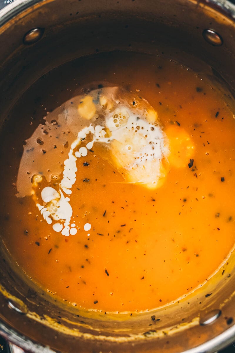 Heavy cream swirled into the finished turkey gravy before it is whisked smooth.