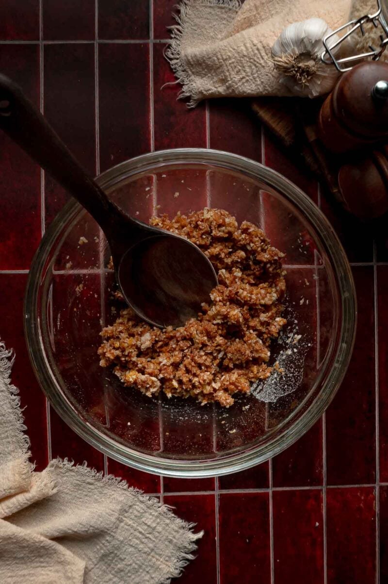 The panko stirred into the egg, BBQ sauce and Worcestershire with a wooden spoon, soaking until the crumbs soften.