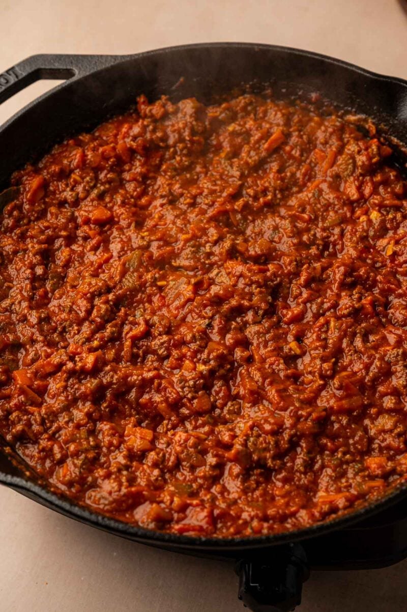 Lamb bolognese simmered down until thick and rich in a cast iron skillet.