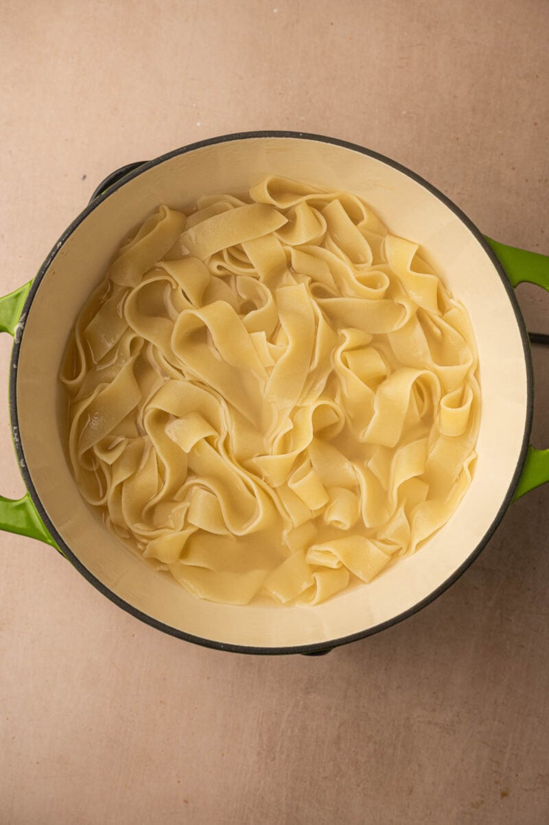 Cooked pappardelle ribbons in the pot, ready to drain.