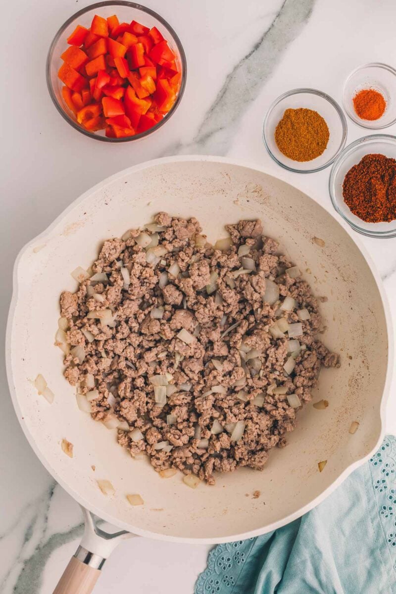 Garlic stirred through the browned ground turkey and onion, ready to go into the slow cooker.
